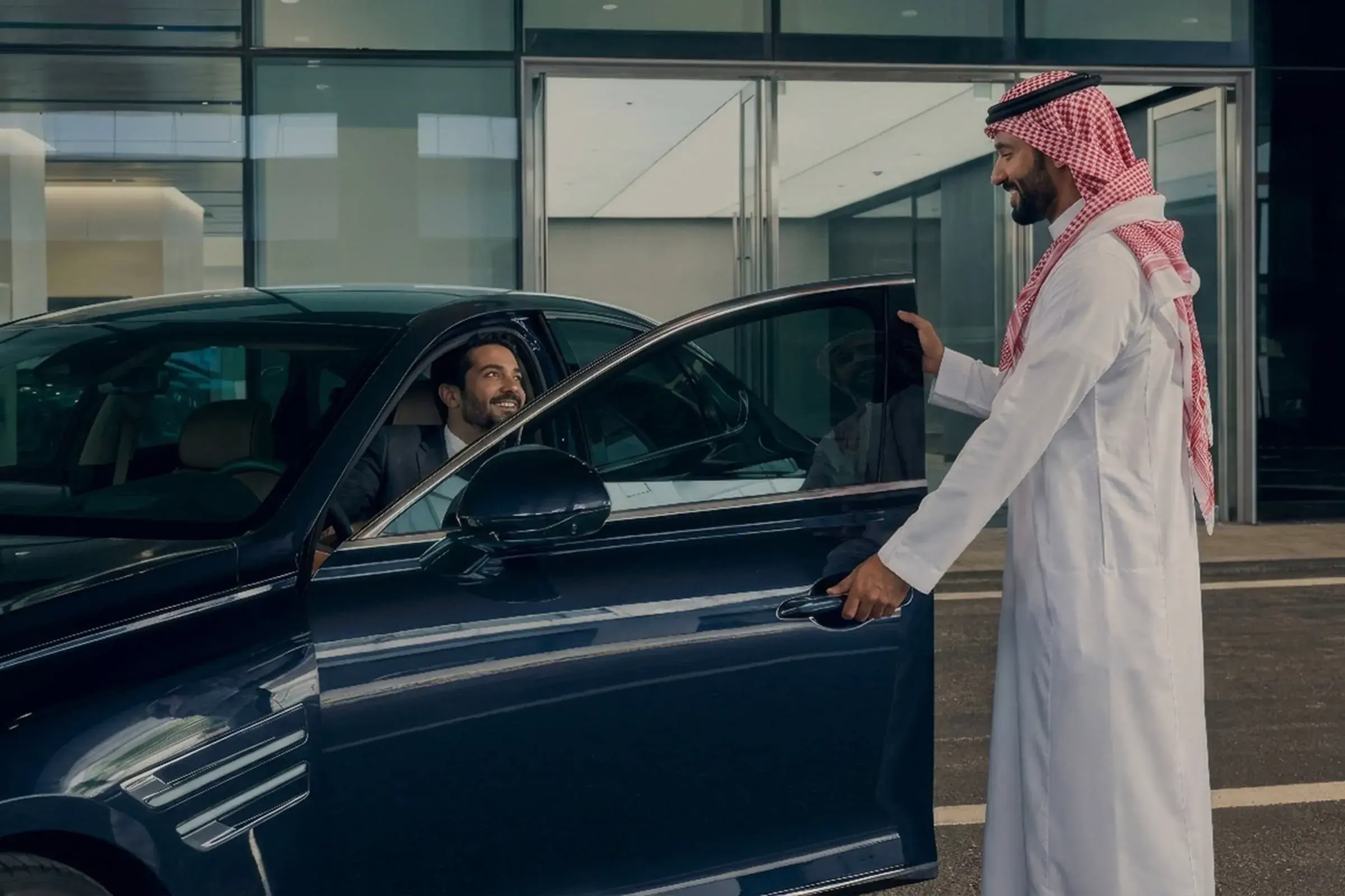 Genesis specialist welcoming a customer into their Certified vehicle